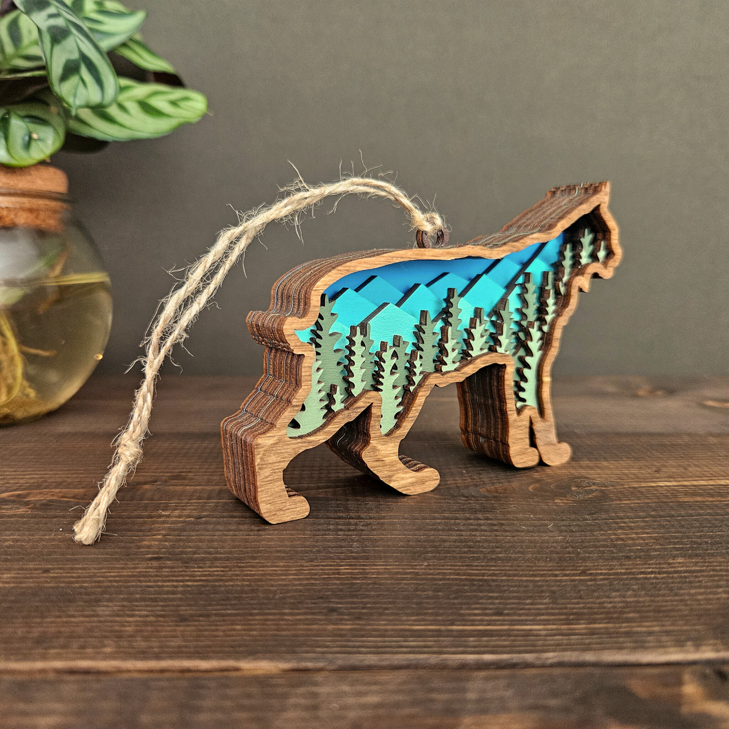 3D layered wood bobcat or lynx Christmas ornament angled view sitting on wood table