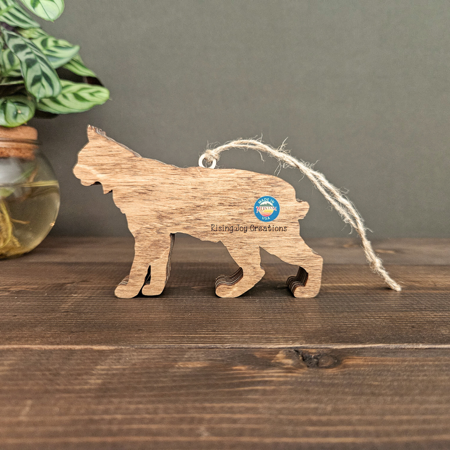 3D layered wood bobcat or lynx ornament view of the back with made in Montana sticker on back