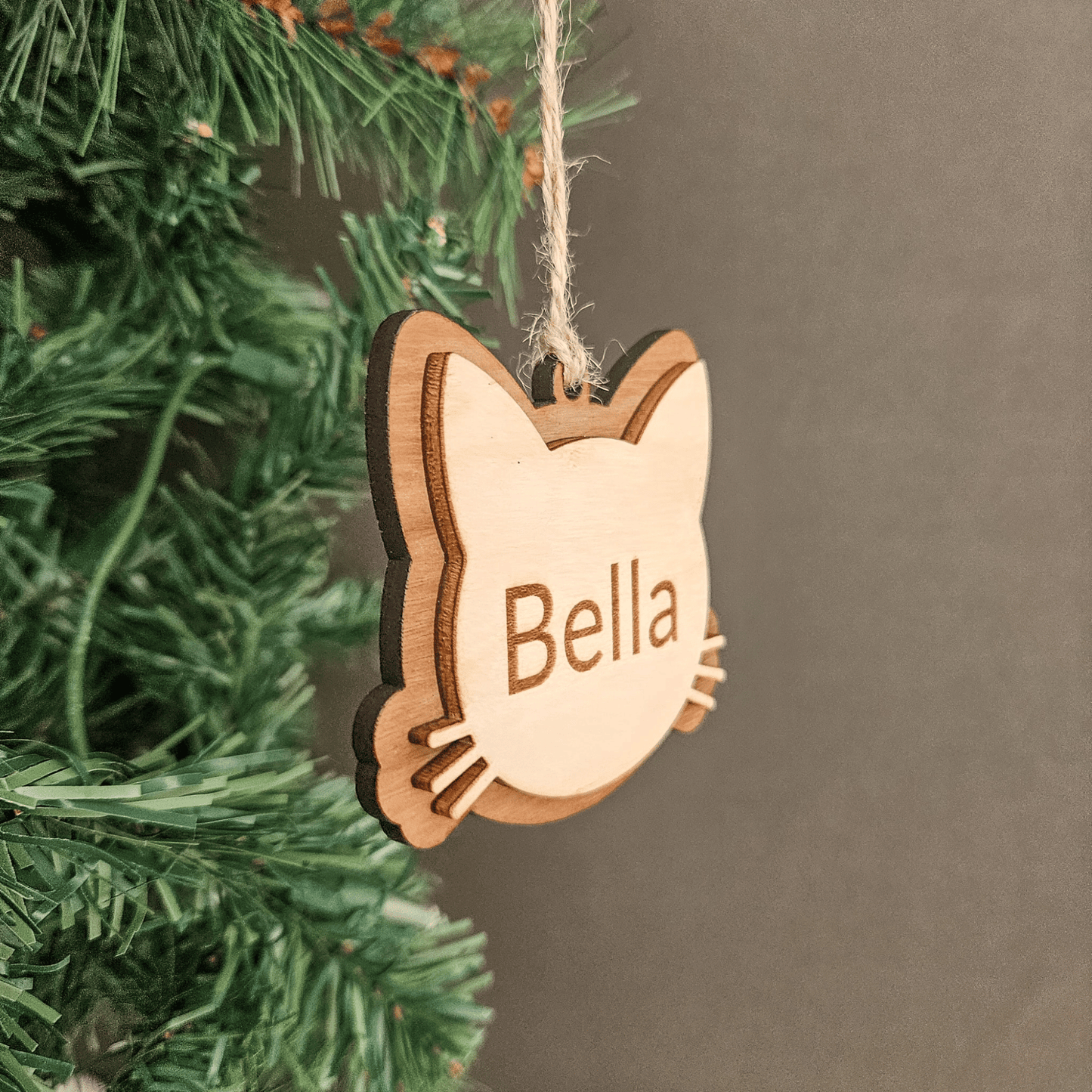 Custom wooden cat ornament with engraved pet name Bella shown as a handcrafted gift for cat lovers