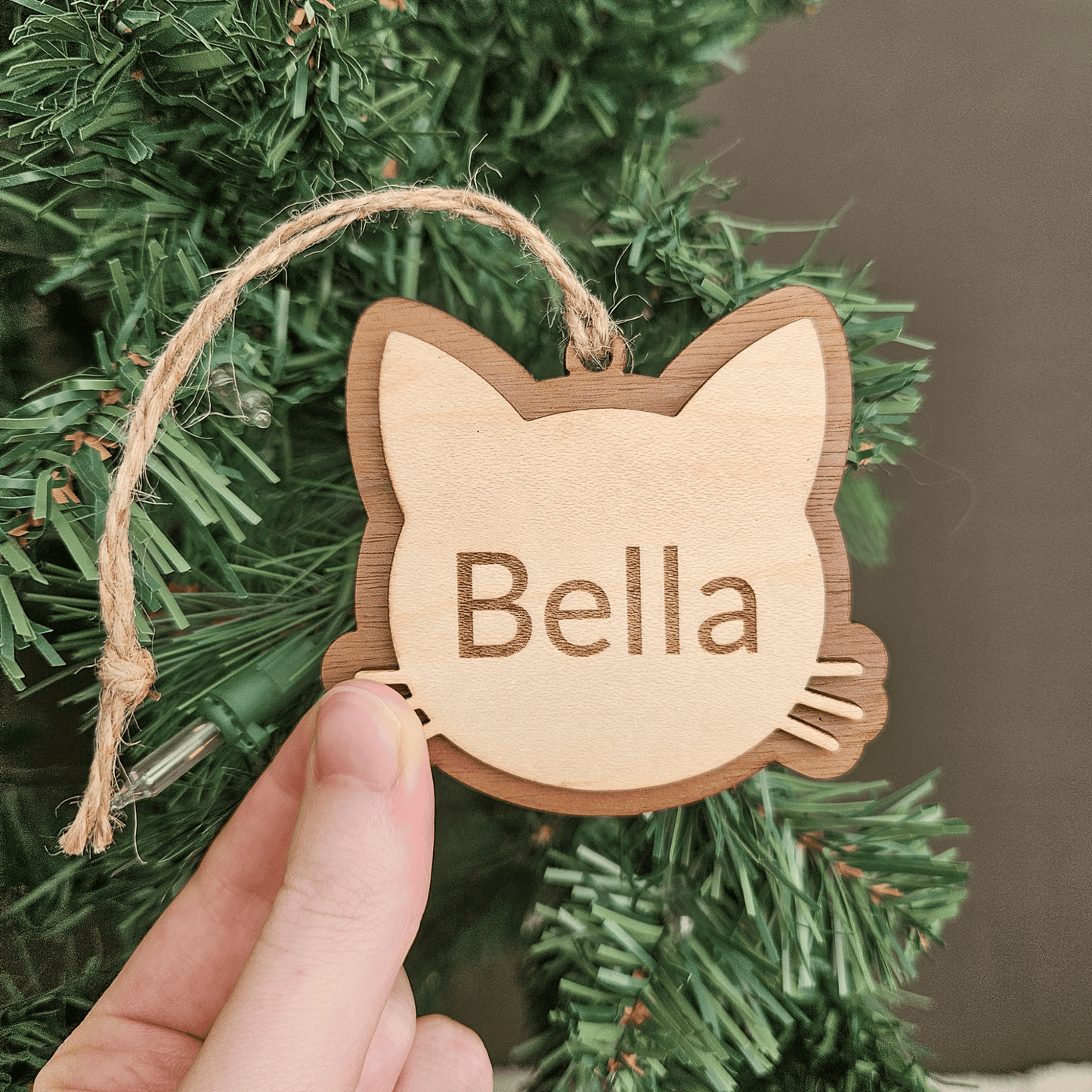Engraved wooden cat ornament personalized with pet name Bella handmade in Montana
