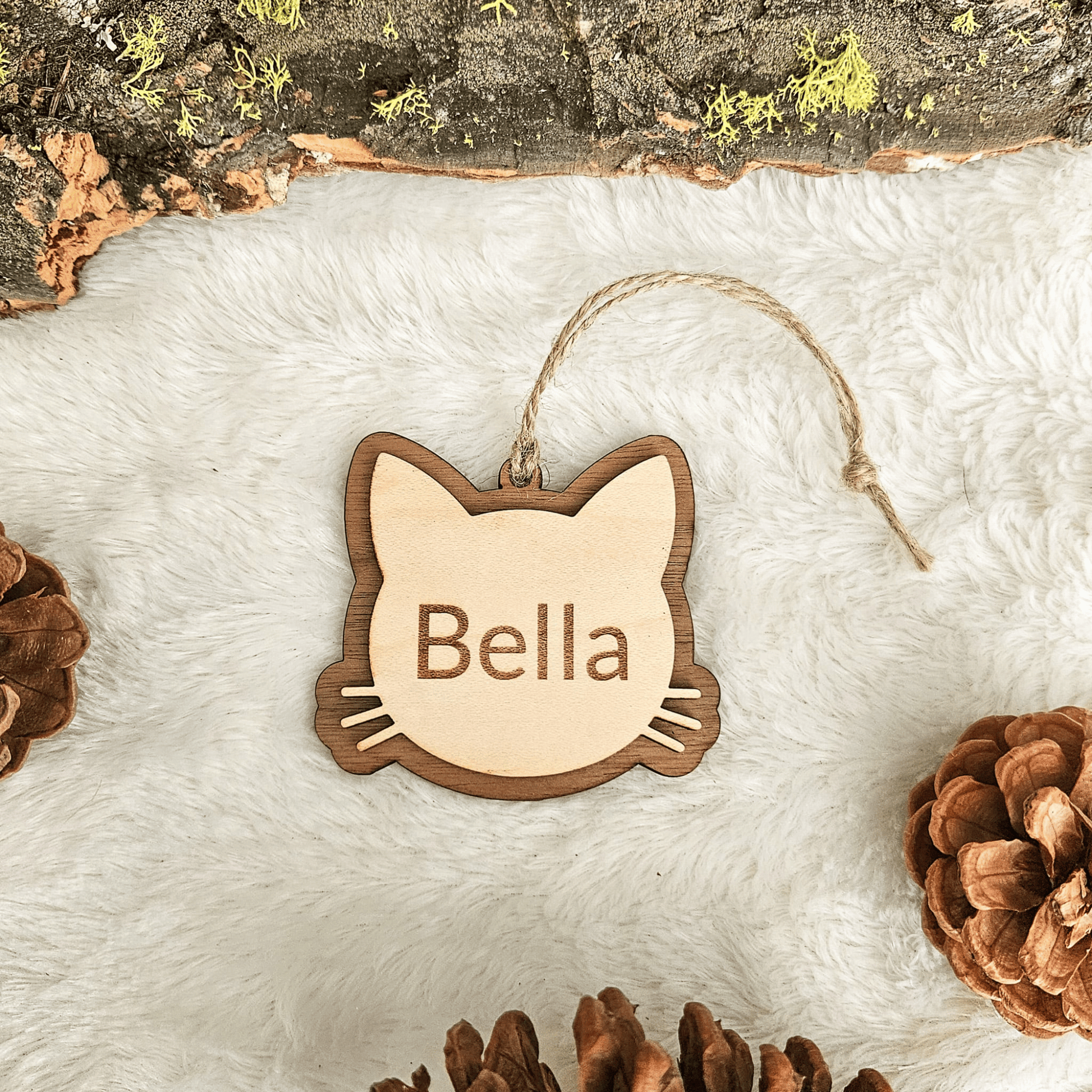 Layered wood personalized cat ornament showing engraved name Bella and handcrafted depth