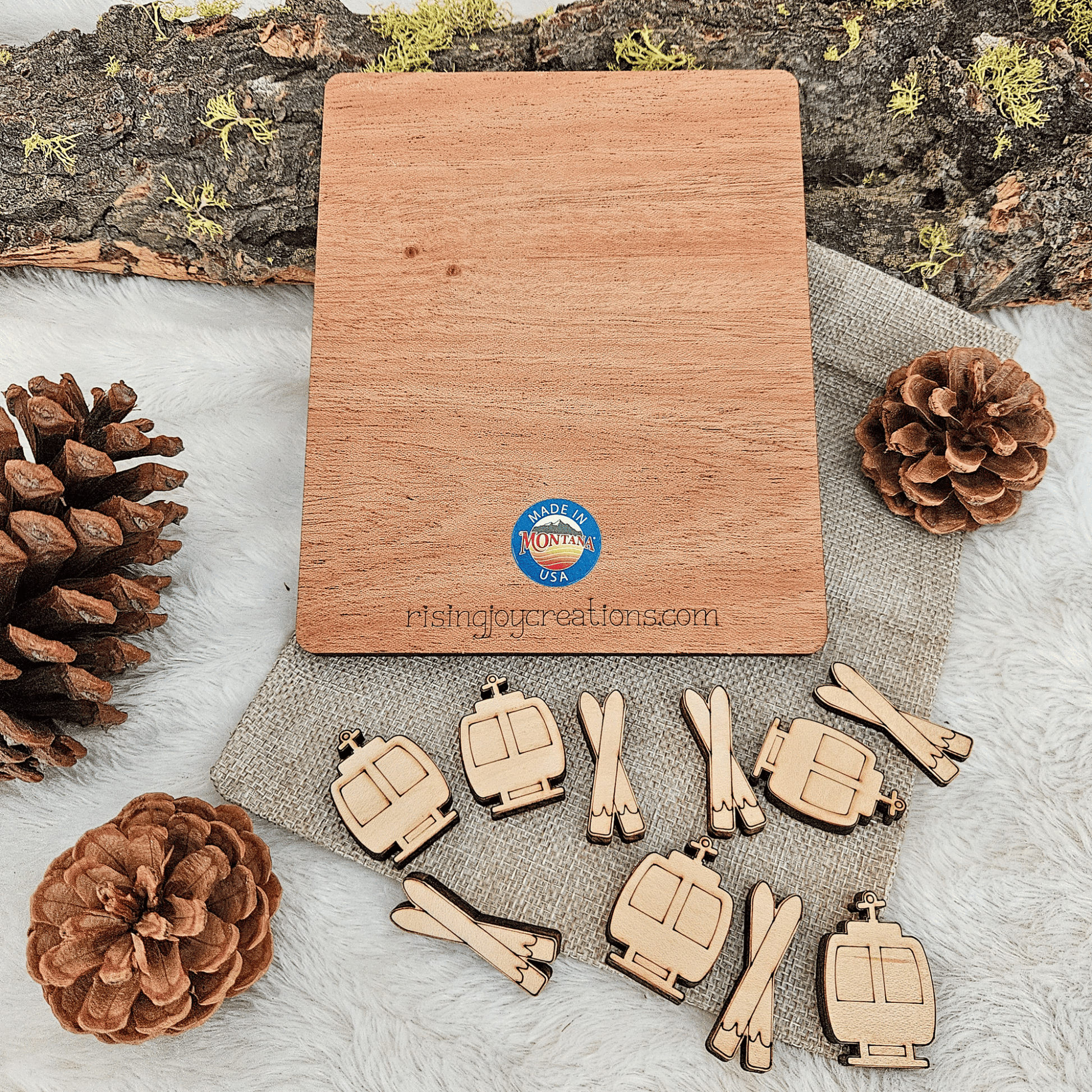 Wooden tic tac toe game and pine cones on a textured surface