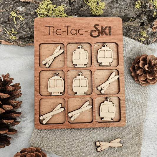 Wooden Tic-Tac-Toe game with ski-themed pieces on a natural background