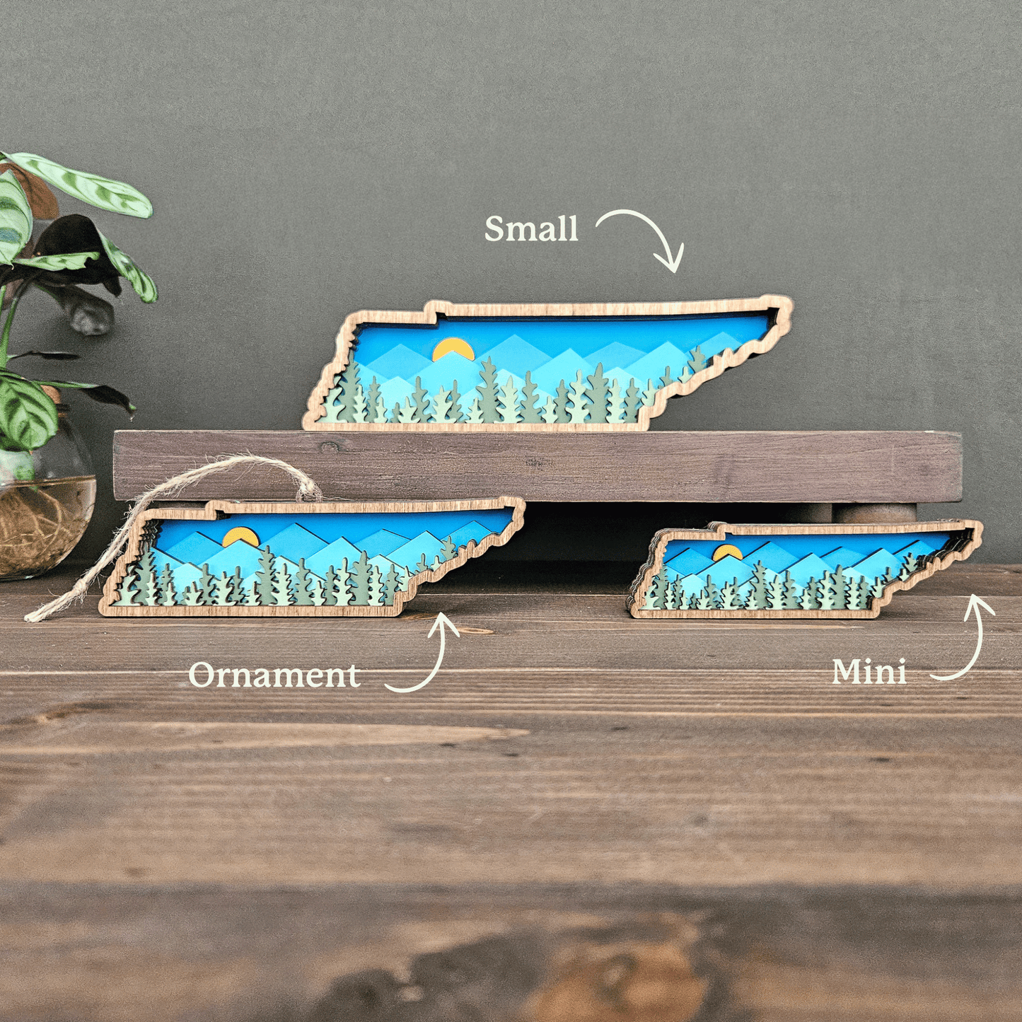 Size comparison of layered Tennessee mountain art labeled small, ornament, and mini — handcrafted wood state decor by Rising Joy Creations.
