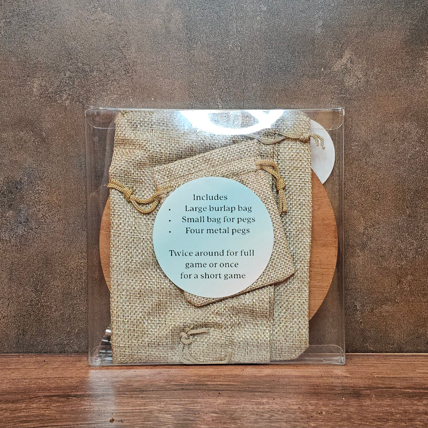 Back of cribbage board packaging with sticker of items included.