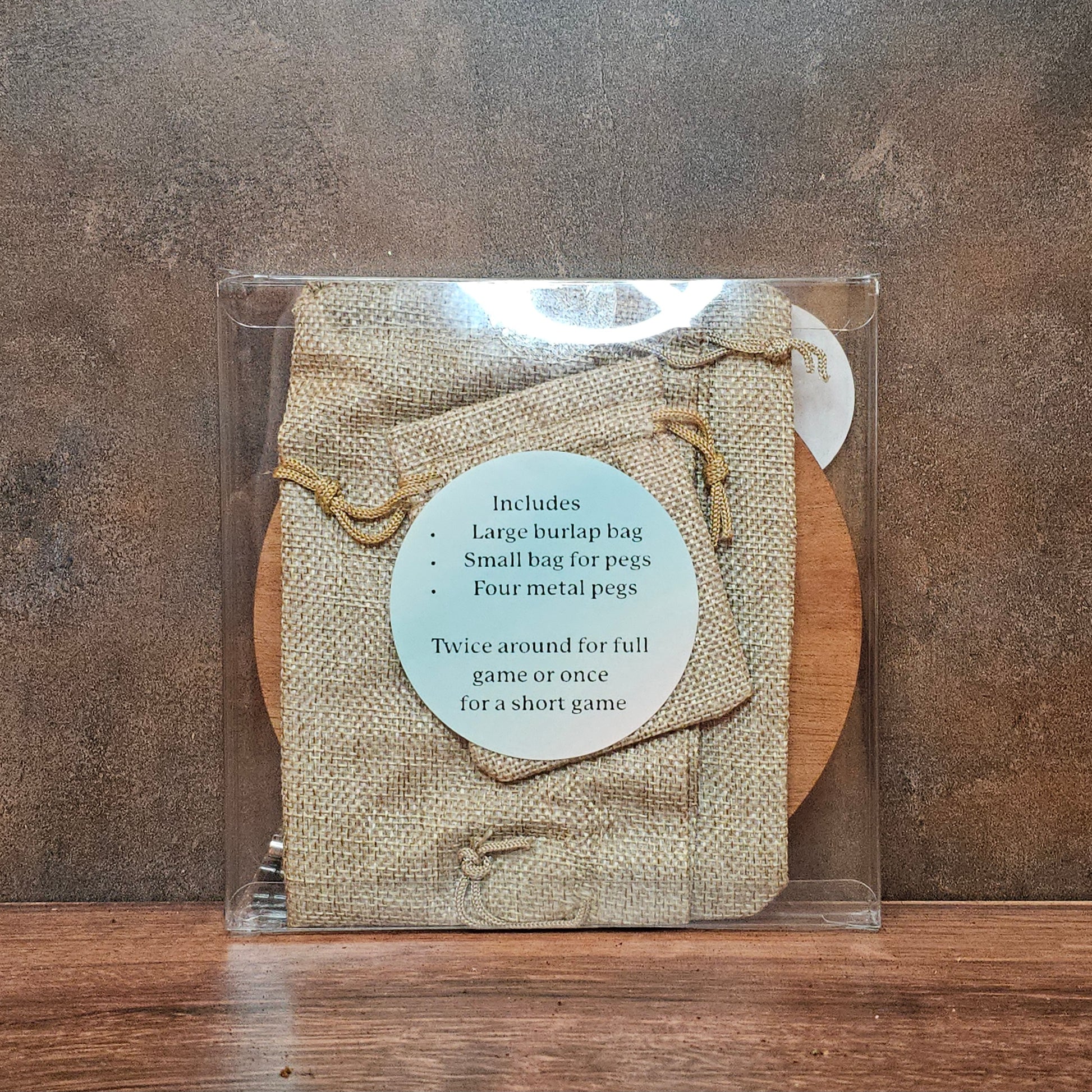 Back of cribbage board packaging with sticker of items included.