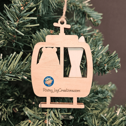 Wooden ski lift ornament with 'Made in Montana USA' logo on a Christmas tree.