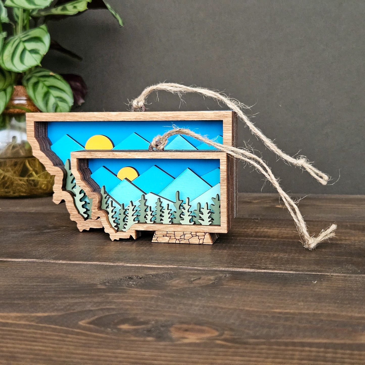 Wooden landscape decoration with trees and sun on a wooden surface
