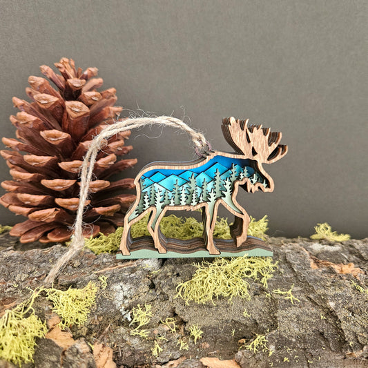 Wooden moose ornament with blue design on a natural background