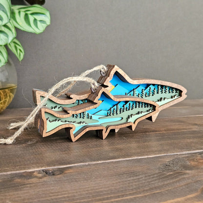 Wooden fish-shaped ornament with cut-out details on a wooden surface