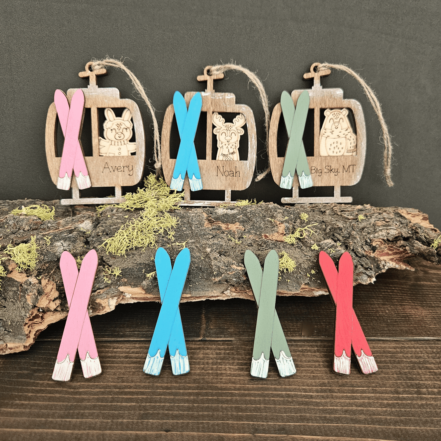Decorative personalized animal wooden ornaments with colorful skis on a rustic wooden surface.