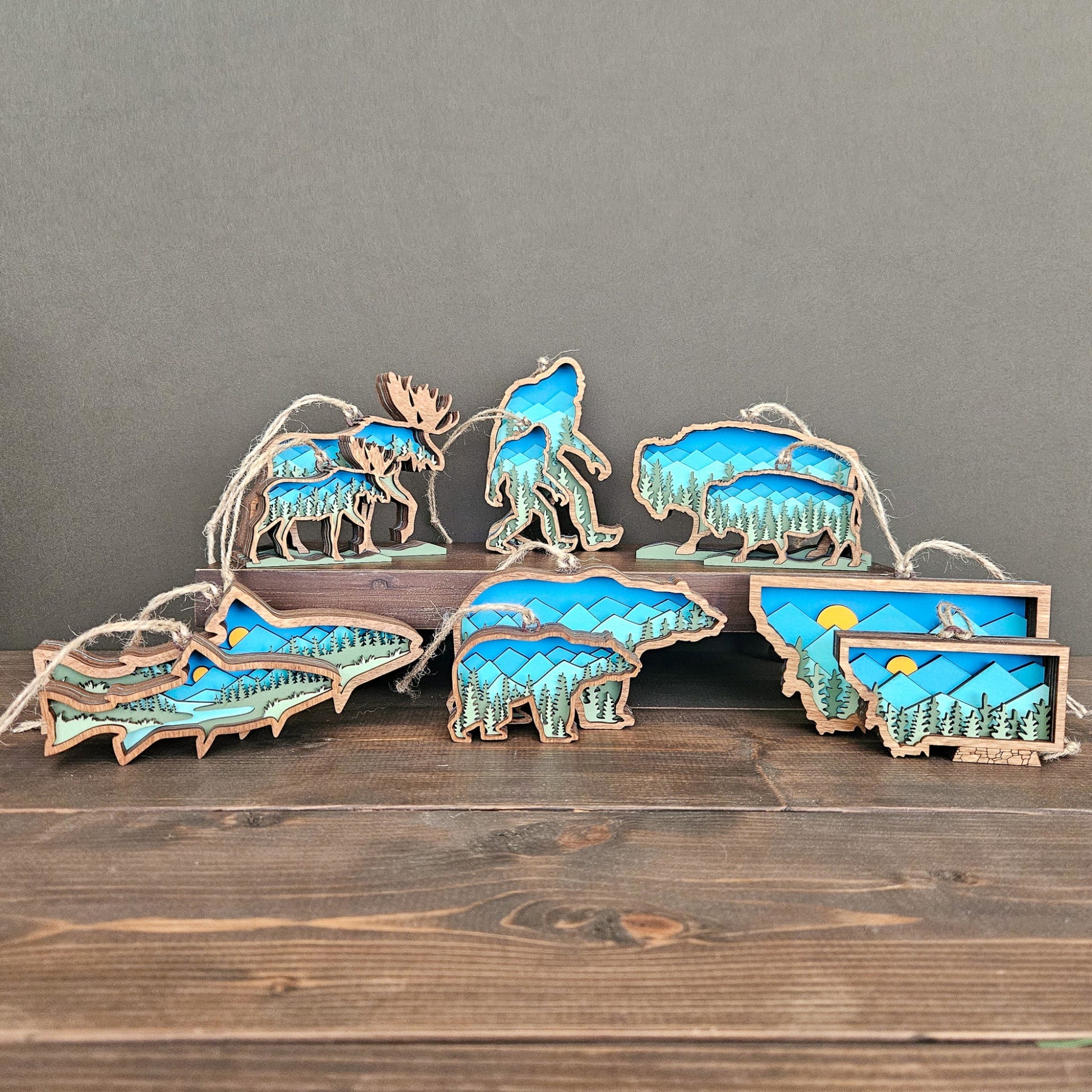 Set of mini wooden animal ornaments with mountains