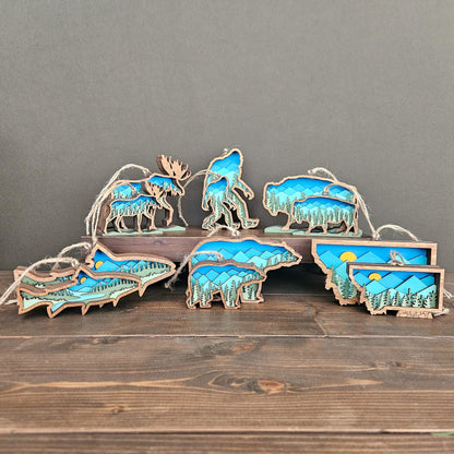 Set of mini wooden animal ornaments with mountains