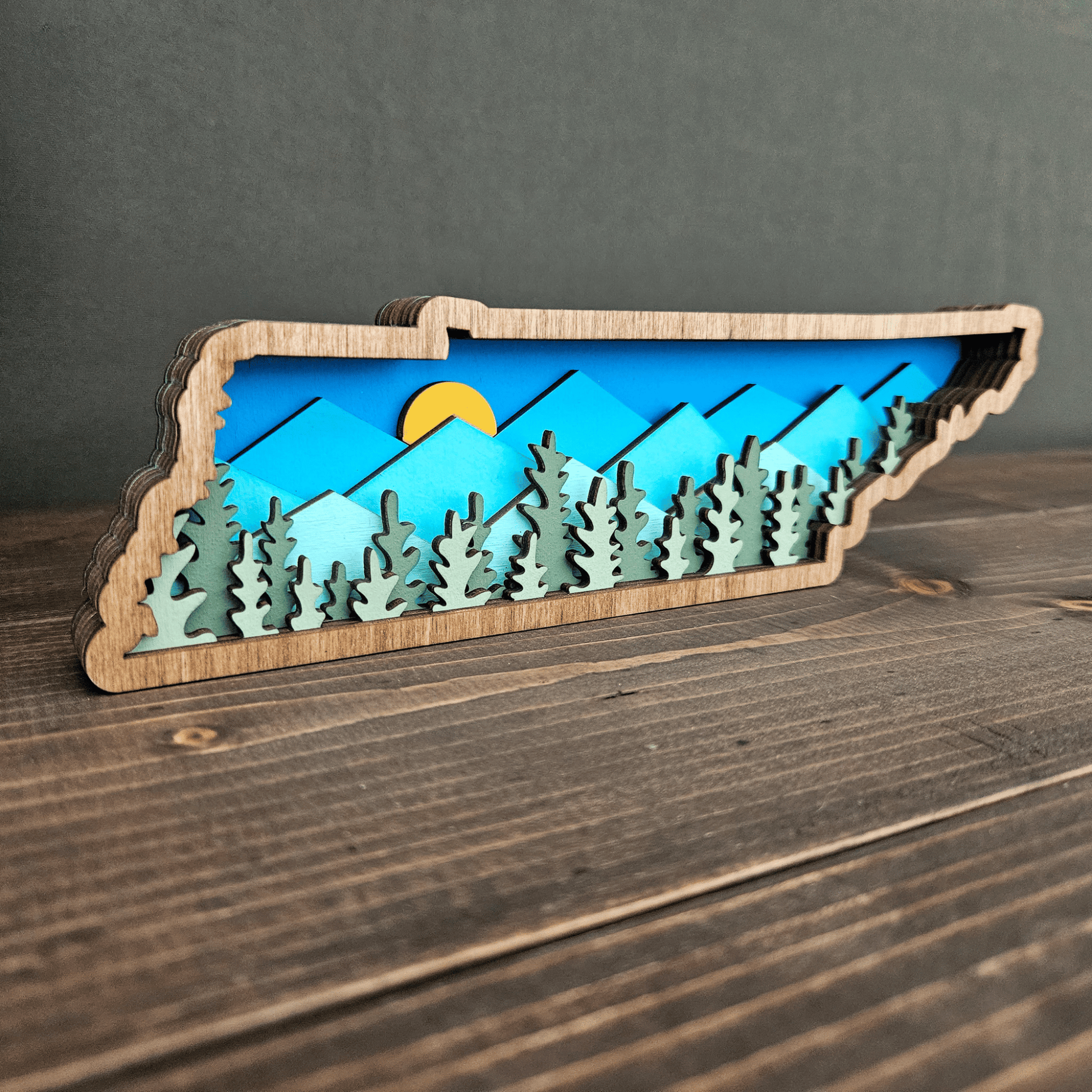 Angled side view of layered Tennessee wood art showing depth and 3D forest detail — handmade mountain state decor.
