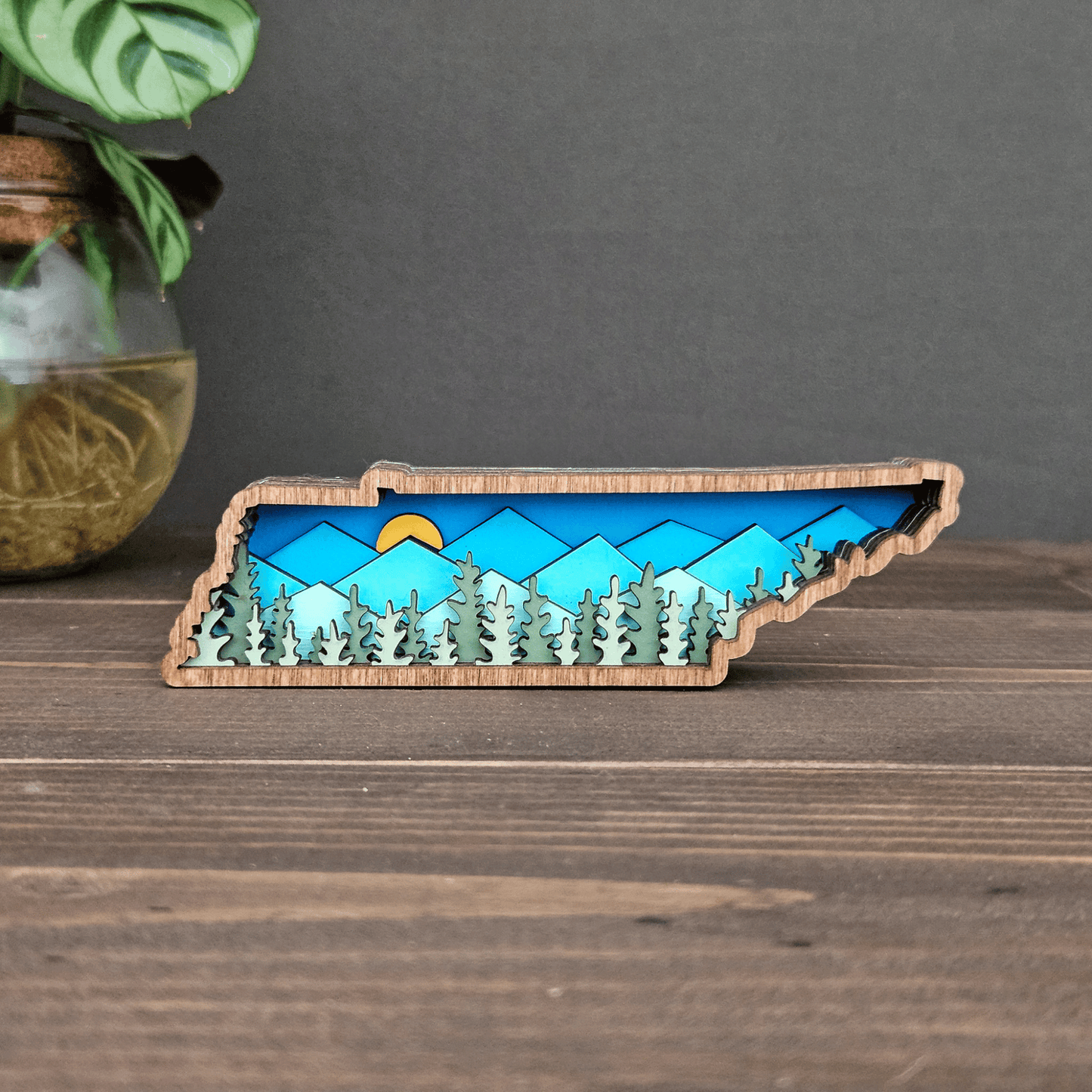 Front view of mini layered Tennessee mountain magnet featuring blue peaks, green trees, and sunrise — handcrafted wooden keepsake.