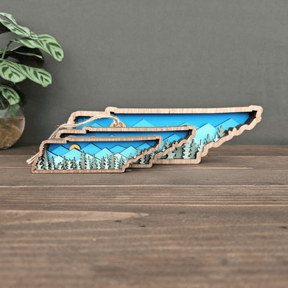 Layered Tennessee mountain magnets in three sizes — mini, ornament, and small — handcrafted wood state art set by Rising Joy Creations.