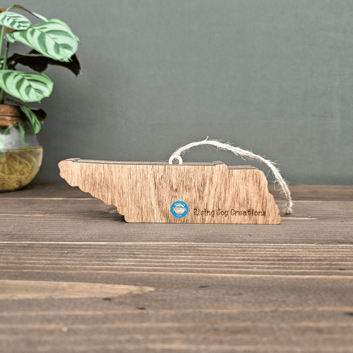 Back view of layered Tennessee ornament engraved with Rising Joy Creations logo and Made in Montana sticker.