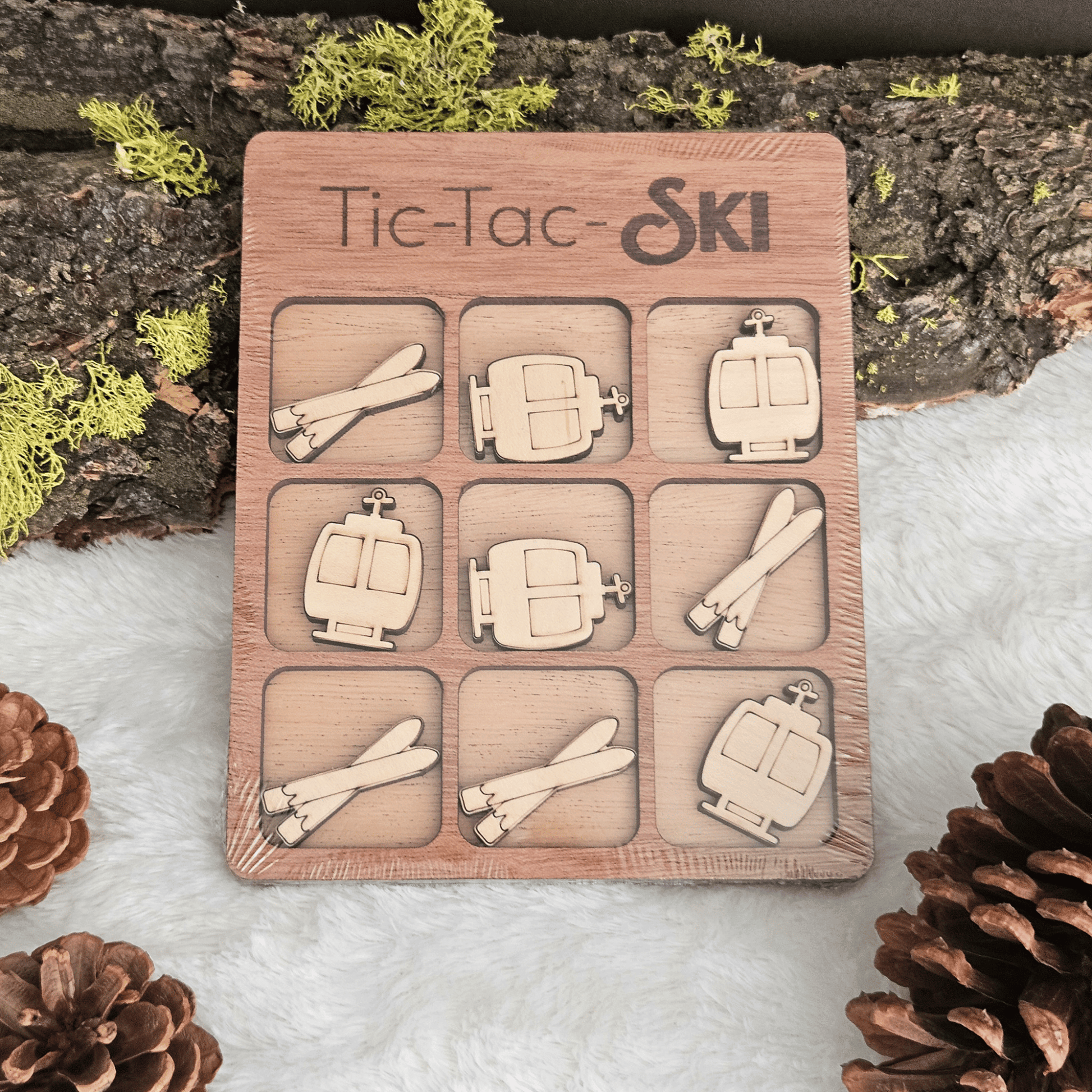 Wooden Tic-Tac-Toe game set with ski-themed pieces on a natural background